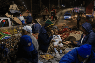 Refugees and families gather at night in Cape Town, South Africa, amid ongoing challenges, highlight.