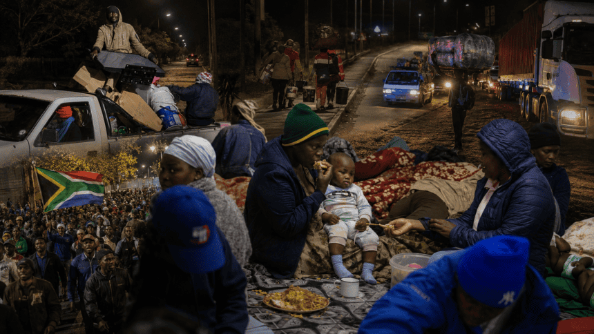 Refugees and families gather at night in Cape Town, South Africa, amid ongoing challenges, highlight.