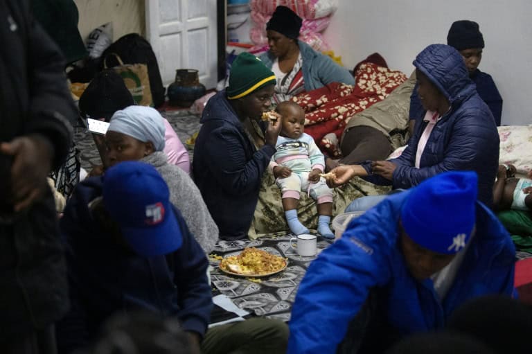 Community gathering with families and children in an indoor setting in Cape Town.