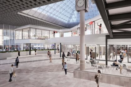Modern airport terminal with travelers and retail shops in Cape Town.