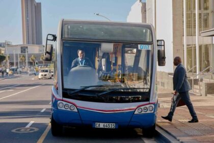 Modern city bus on a busy urban street in Cape Town, South Africa.