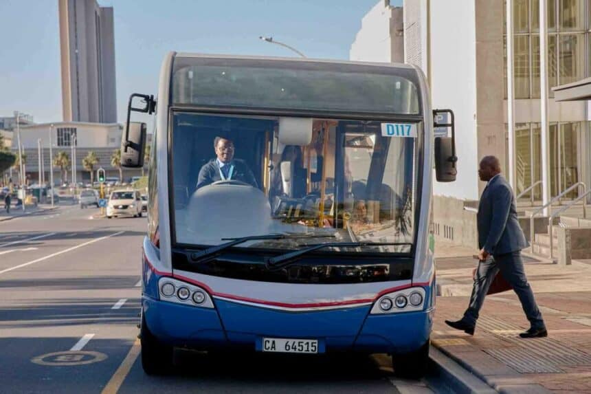 Modern city bus on a busy urban street in Cape Town, South Africa.