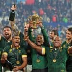 South African rugby team with trophy and medals after winning a major match.
