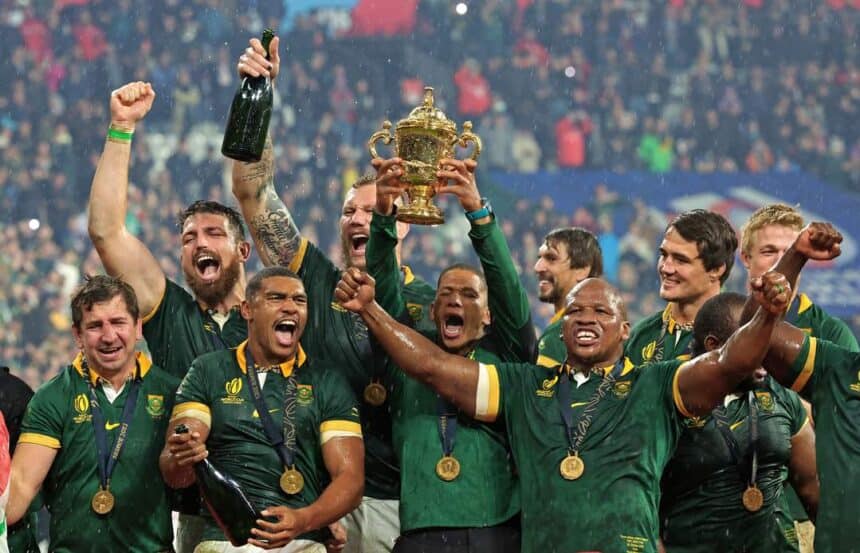 South African rugby team with trophy and medals after winning a major match.